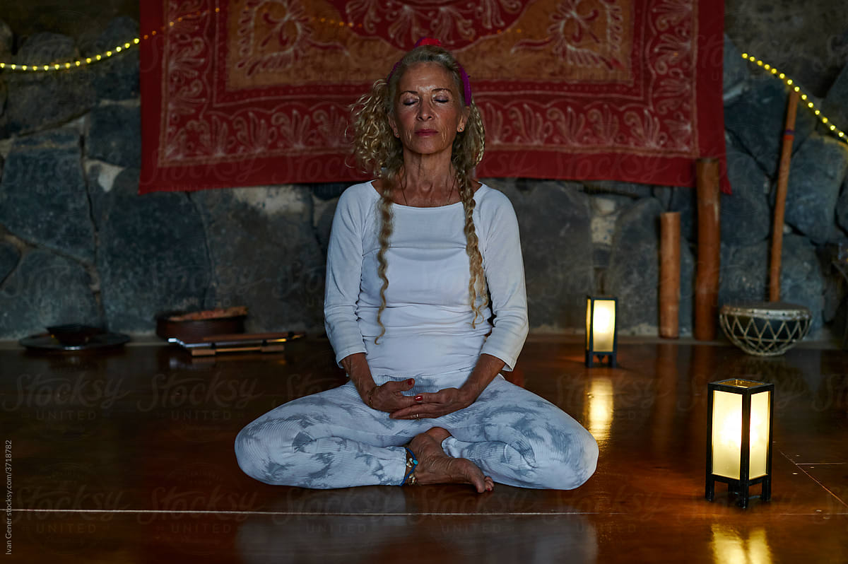 Senior woman meditating during a retreat