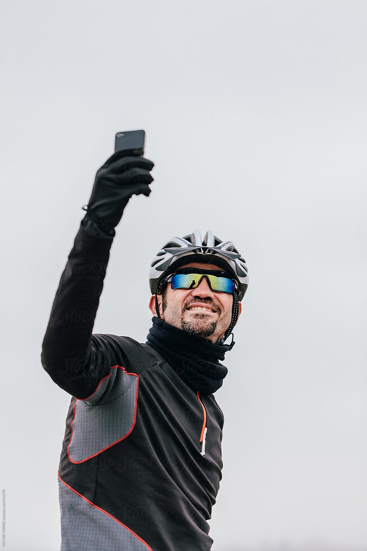 Mountain Bike Rider Taking a Selfie Over a White Sky