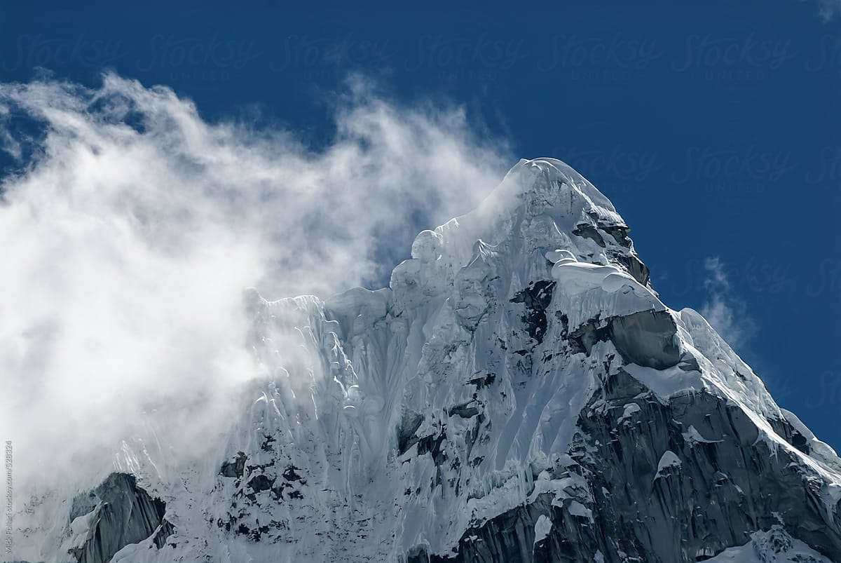 Dramatic icy mountain summit with cornices and steep couloirs