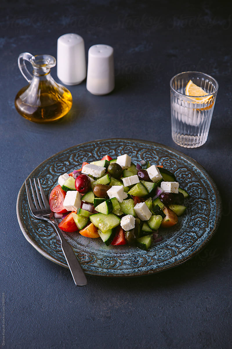 Plate of Greek Salad with Lemon Water