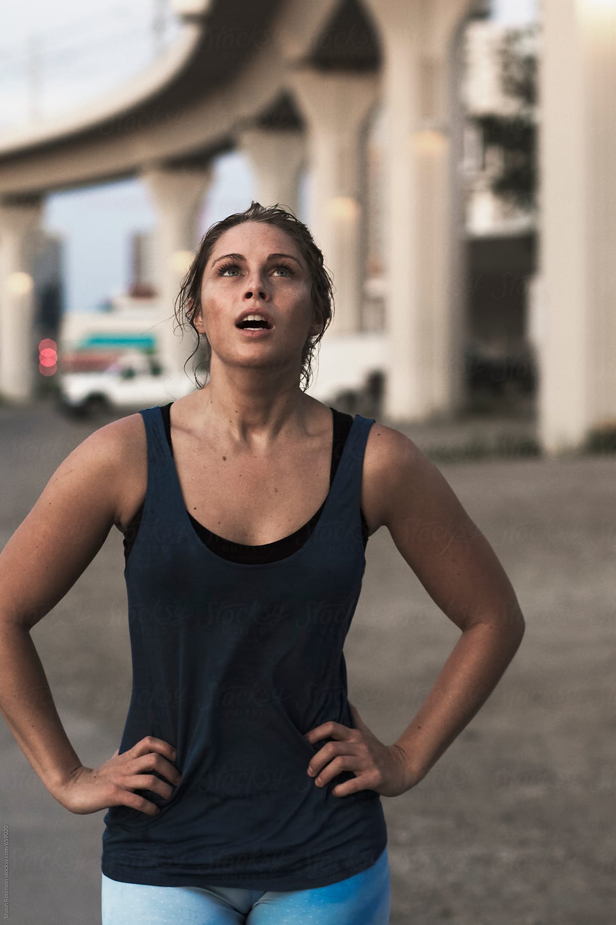 A fit woman catching her breath after running