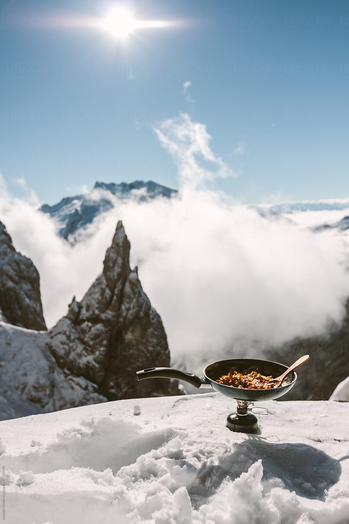 scrambled eggs on a gas cooker in snowcovered mountain scenery