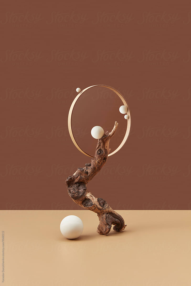 Showcase with wood, white spheres and metal ring.