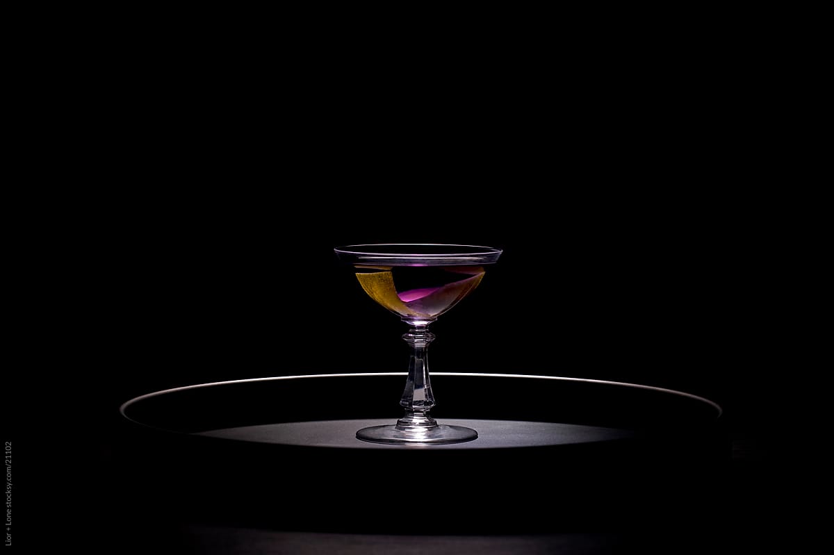 Purple cocktail on round tray