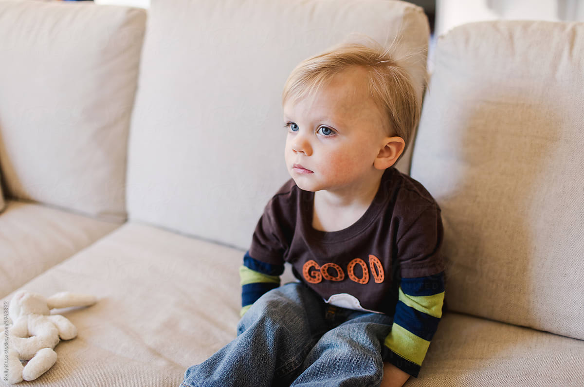 serious toddler watches tv