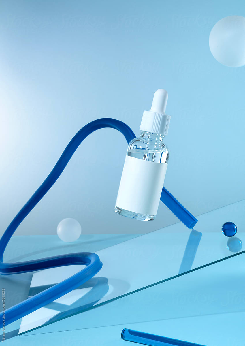 A bottle of cosmetics levitating on a blue background