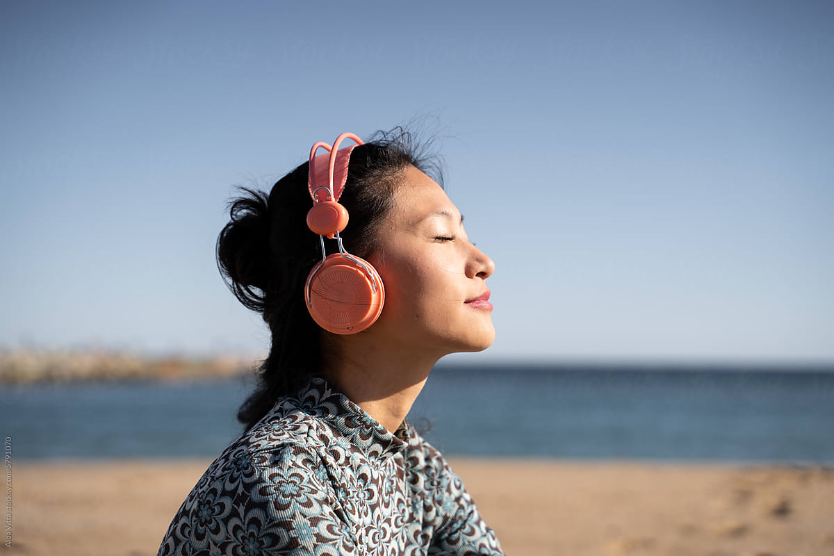 Woman listening music at beach