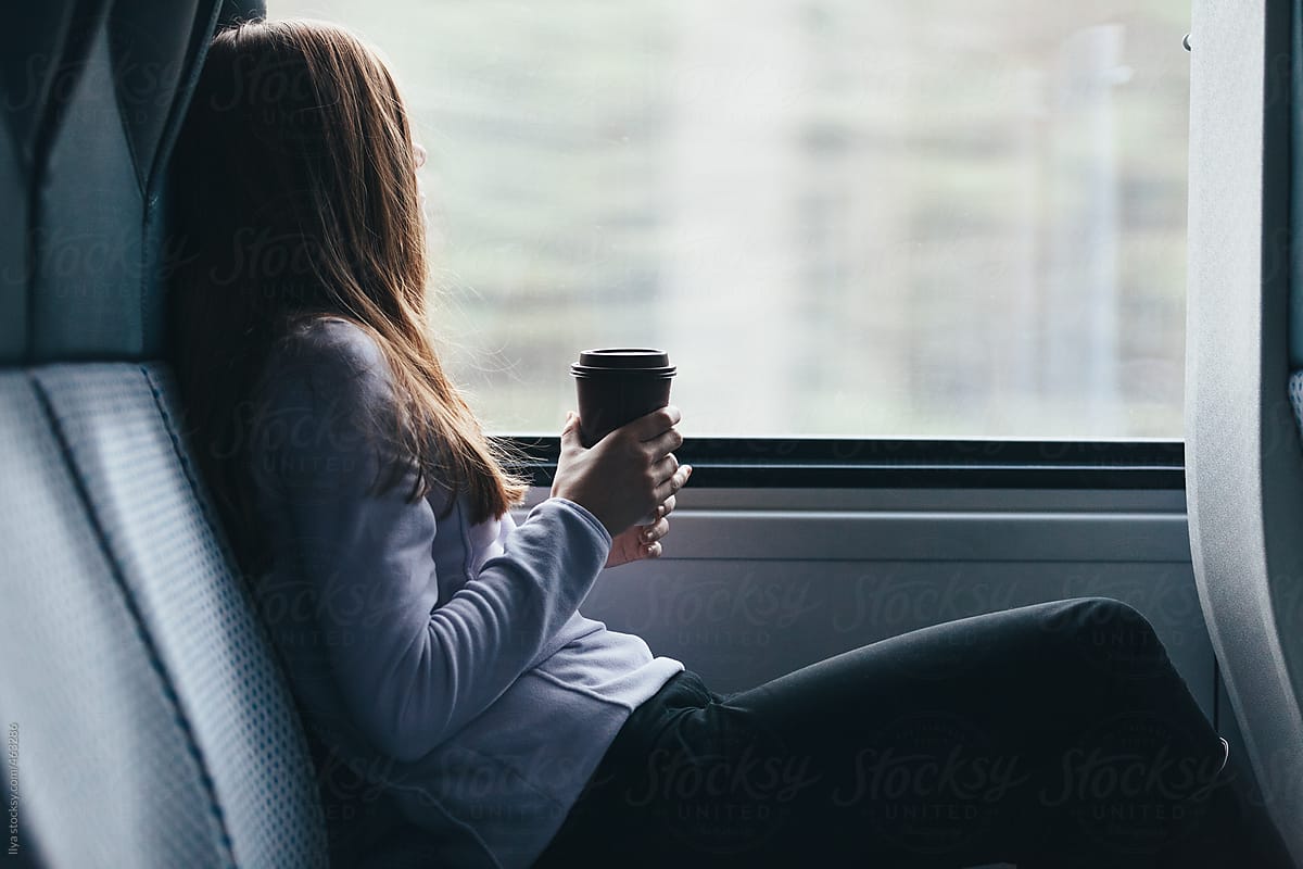 Woman travel by train with coffee