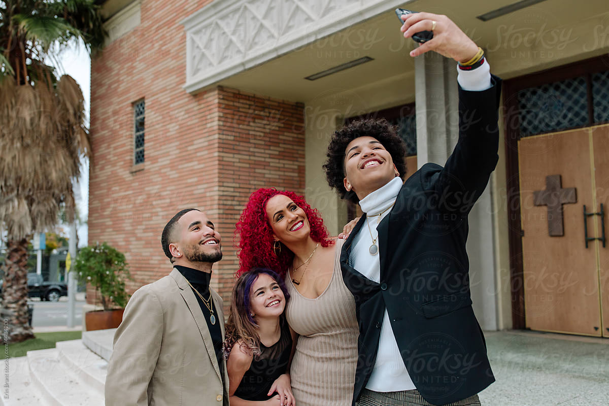 Black family taking selfie on church steps