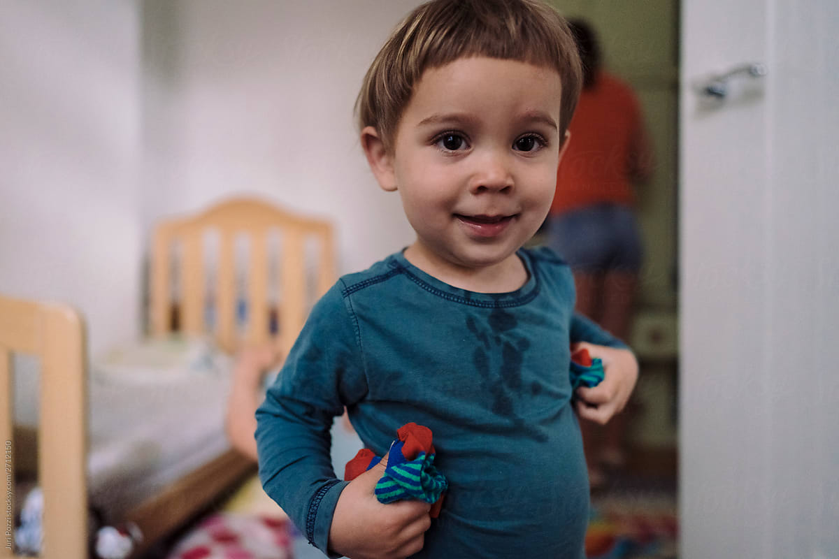 Toddler with short hair in wet shirt in nursery