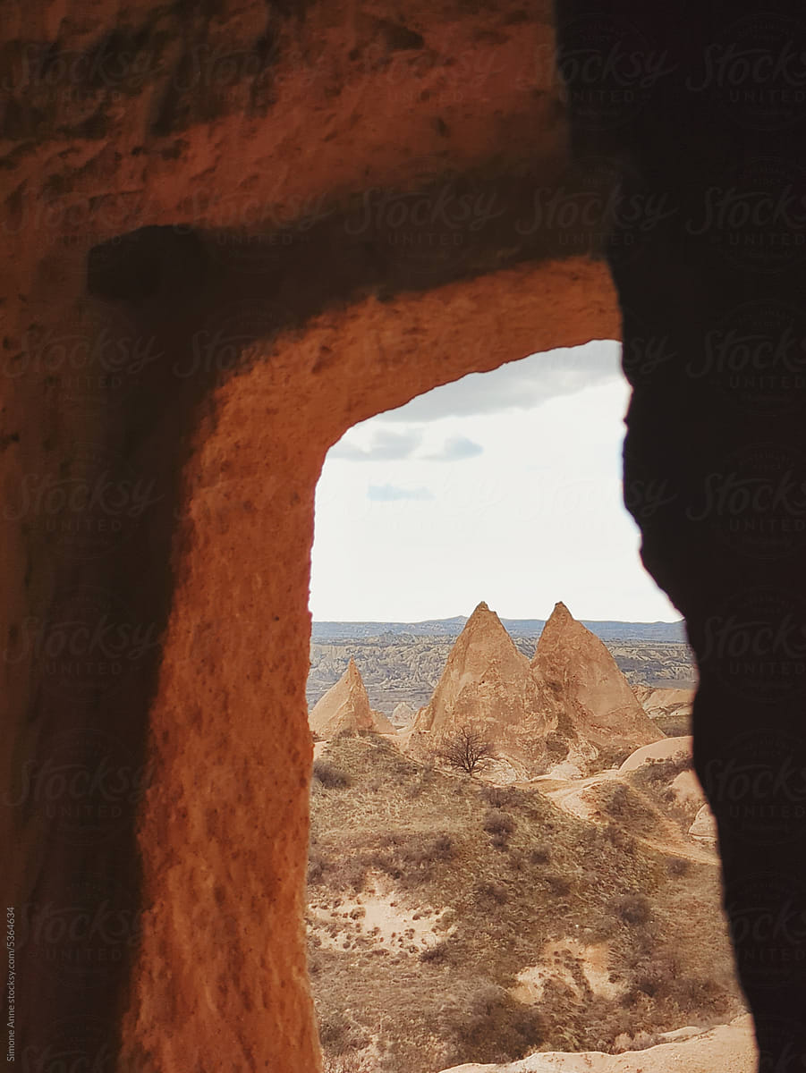 Peaked rock formations through a rock window