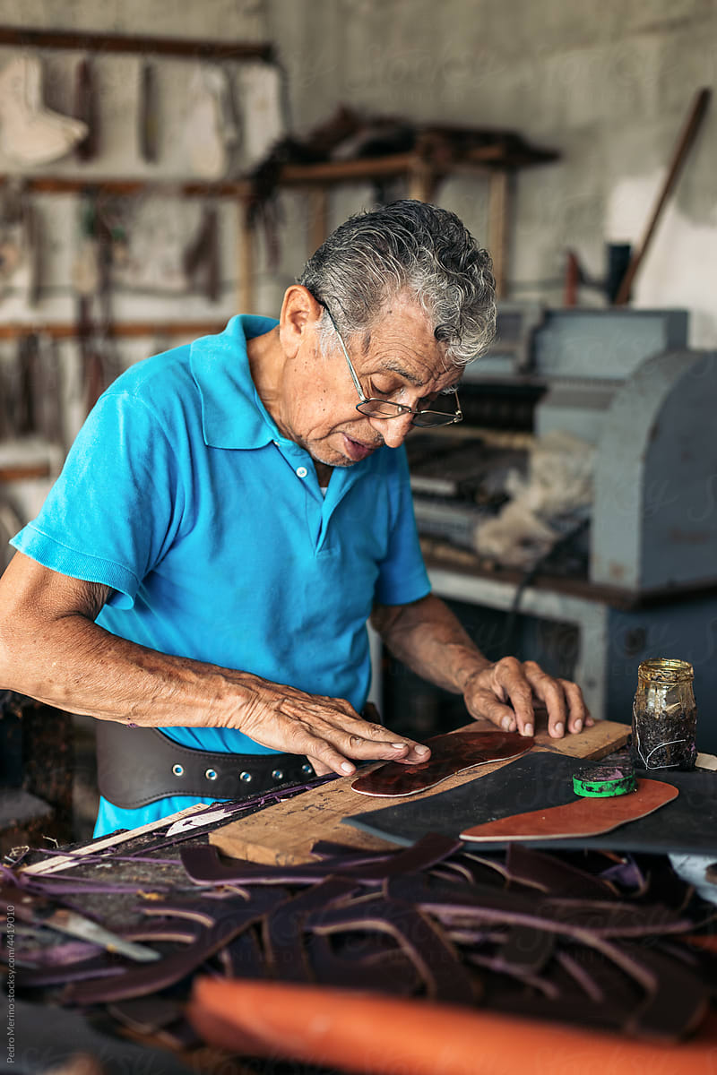 Older shoemaker working in his workshop