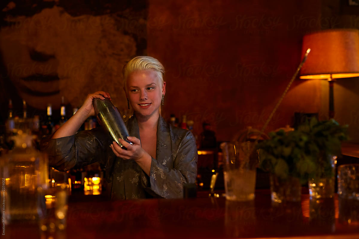A mixologist holding a cocktail shaker