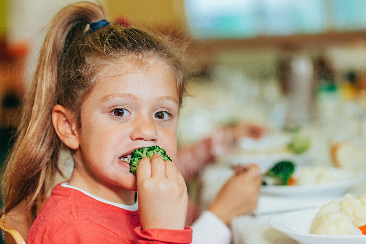 Kindergarten Kids Eating At School Canteen by Stocksy Contributor VICTOR  TORRES - Stocksy