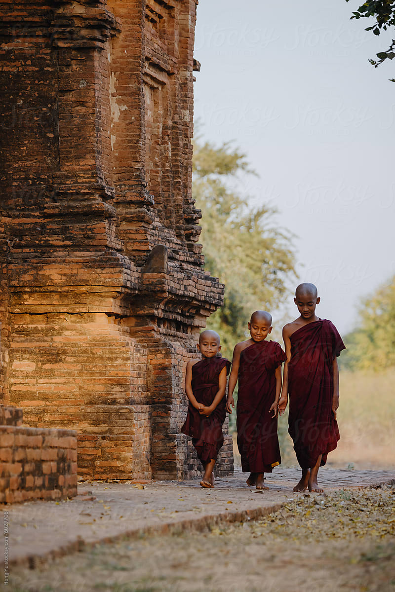 Monks walking beside the ancient temple