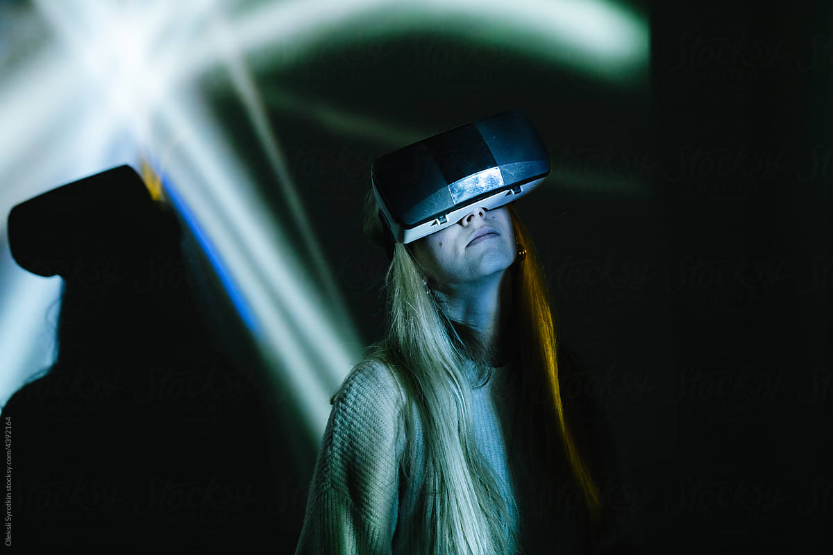 Girl using VR glasses over black background