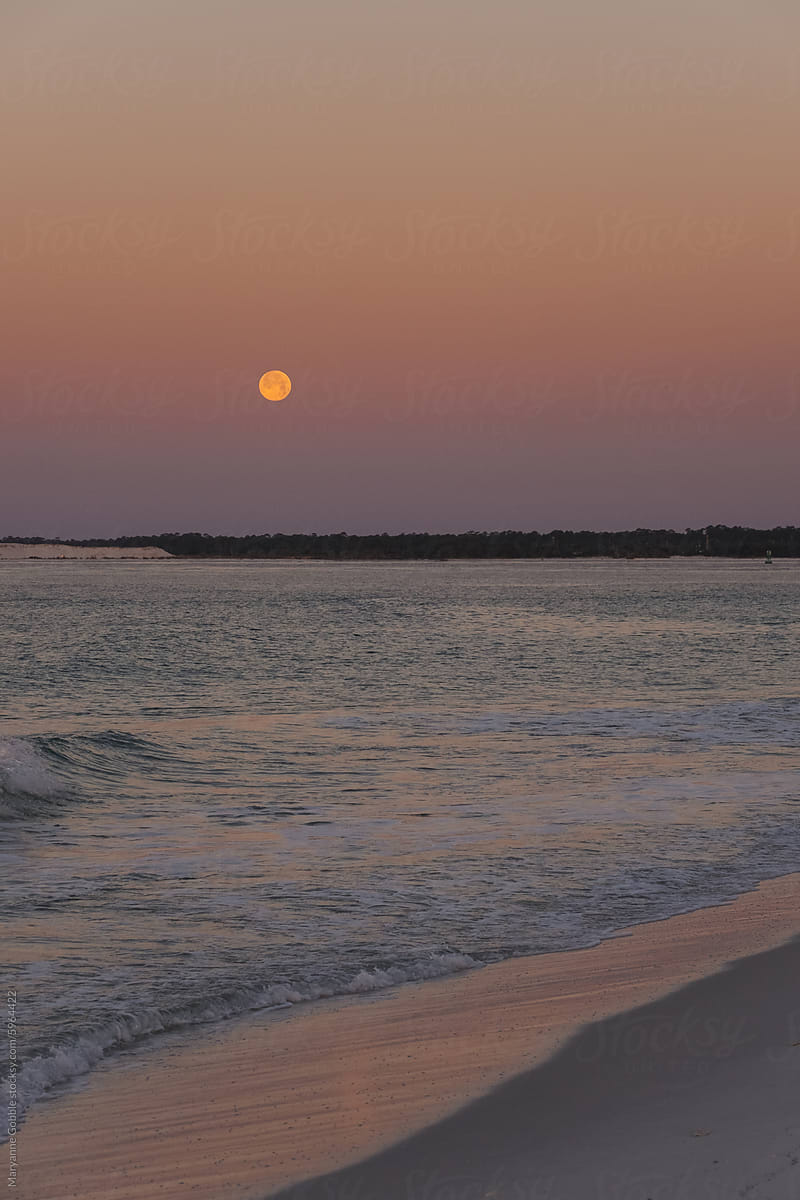 Full Moon in Sky over Ocean During Sunset