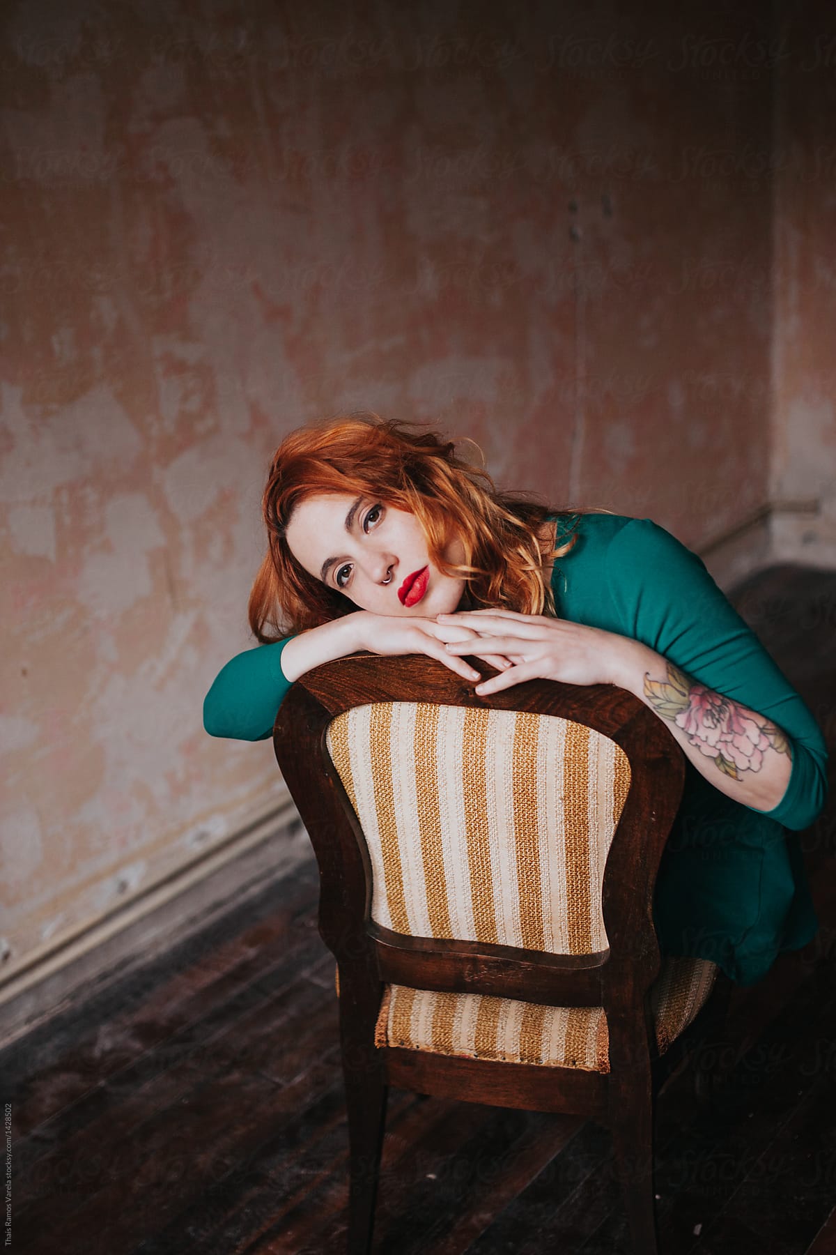 Portrait Os A Ginger Woman Sitting On A Chair In A Empty Room By Stocksy Contributor Thais