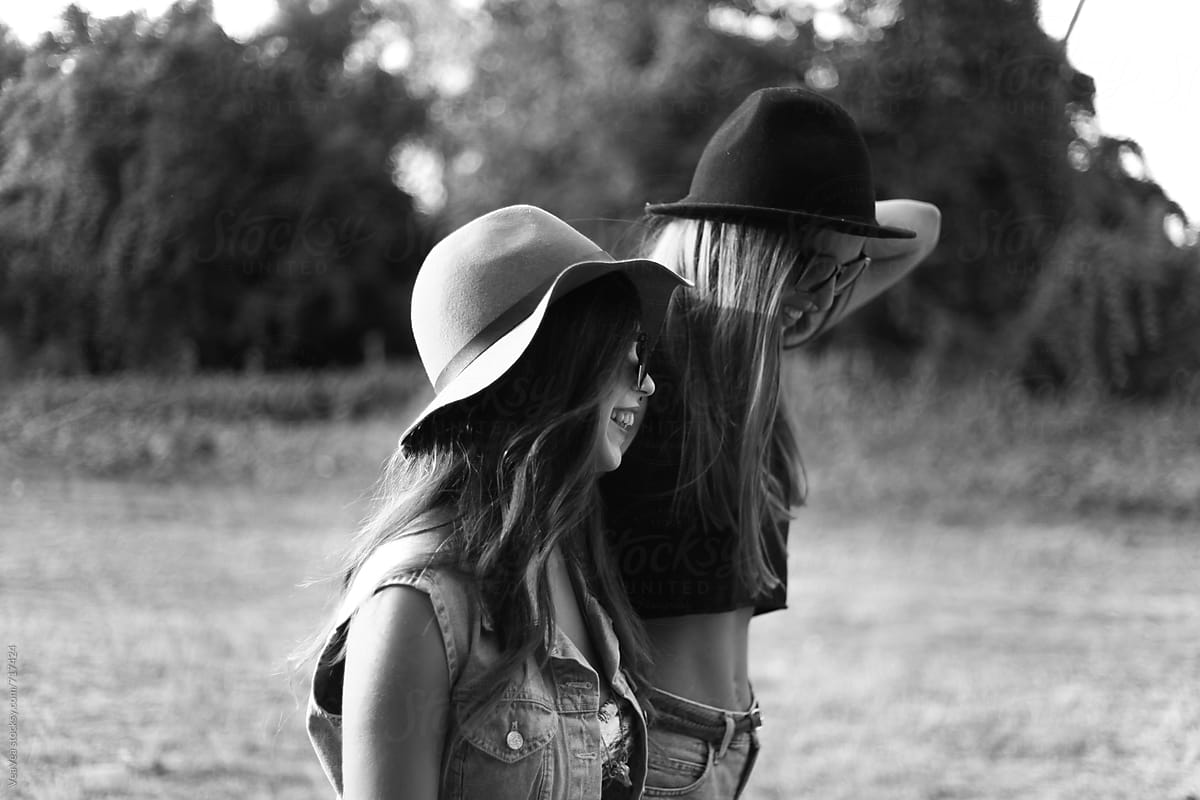 Two stylish female friends laughing. Black and white.