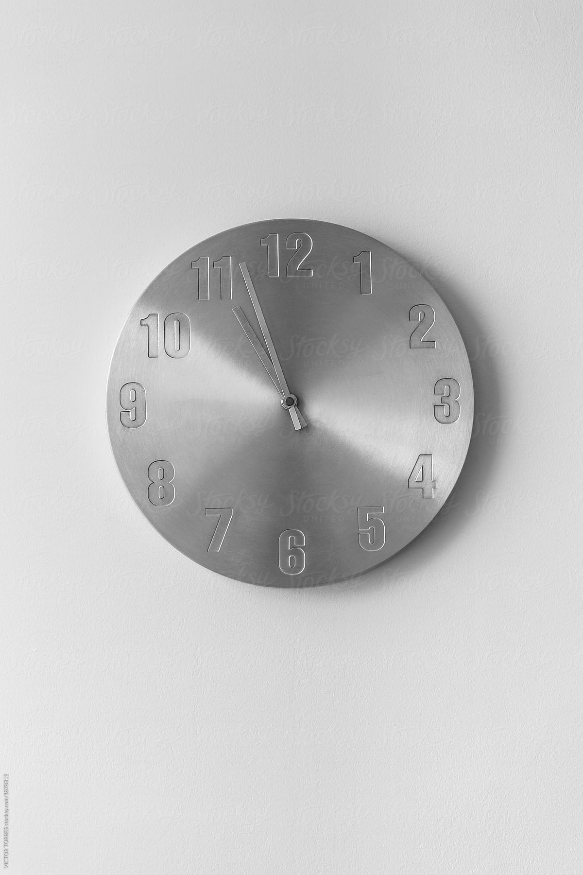 Metal clock on a white wall