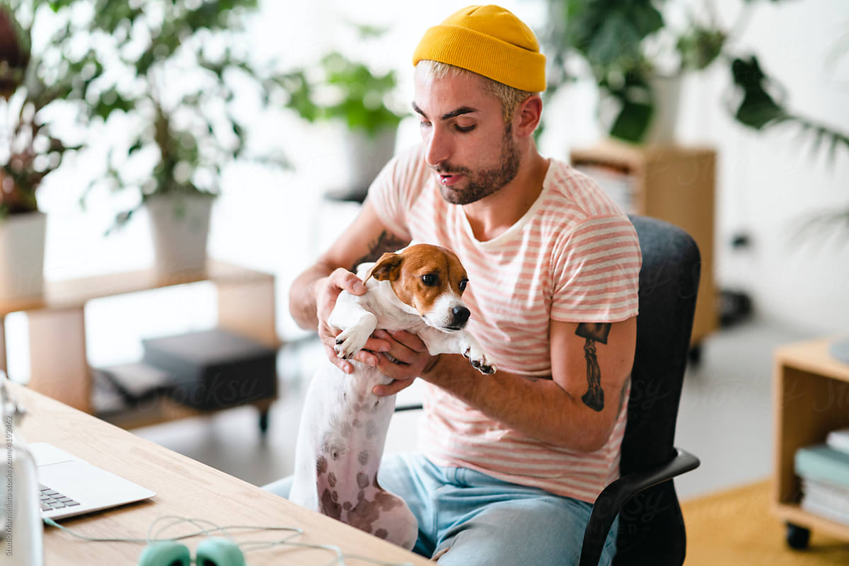 Man with dog in home office