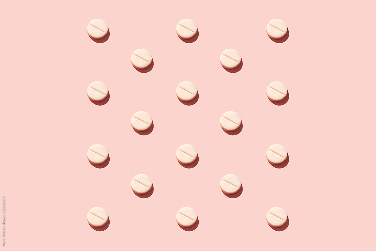 Pills on pink background.