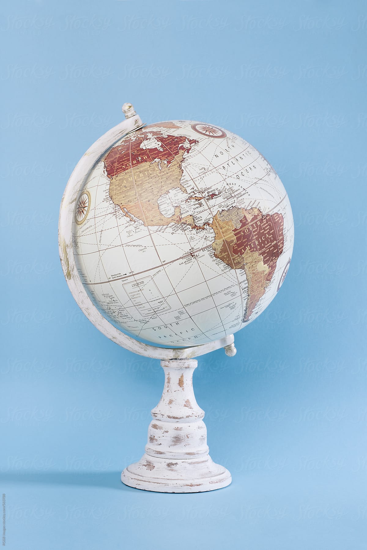 Wooden world globe on blue background