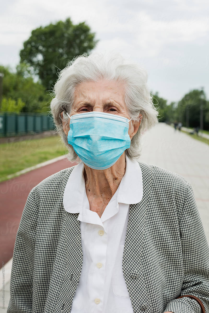 Senior woman outside wearing a medical mask