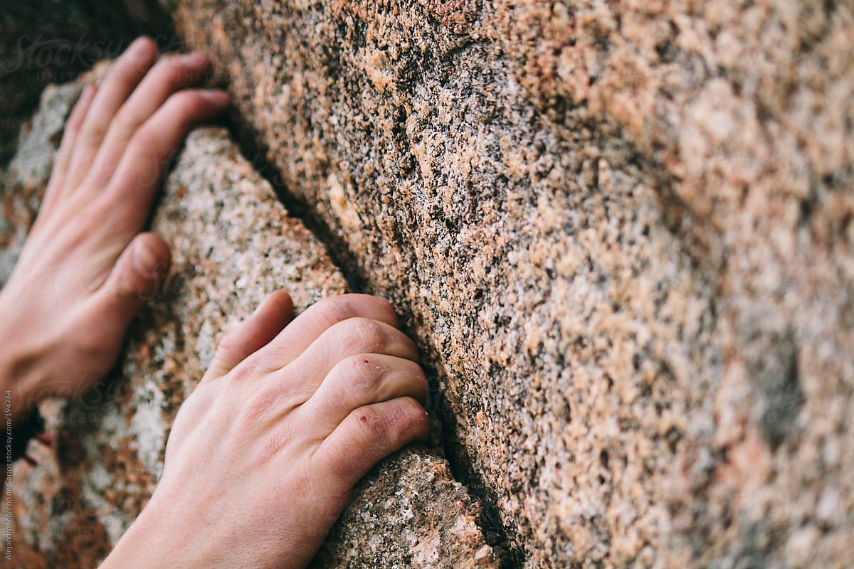 Close up of hands rock climbing