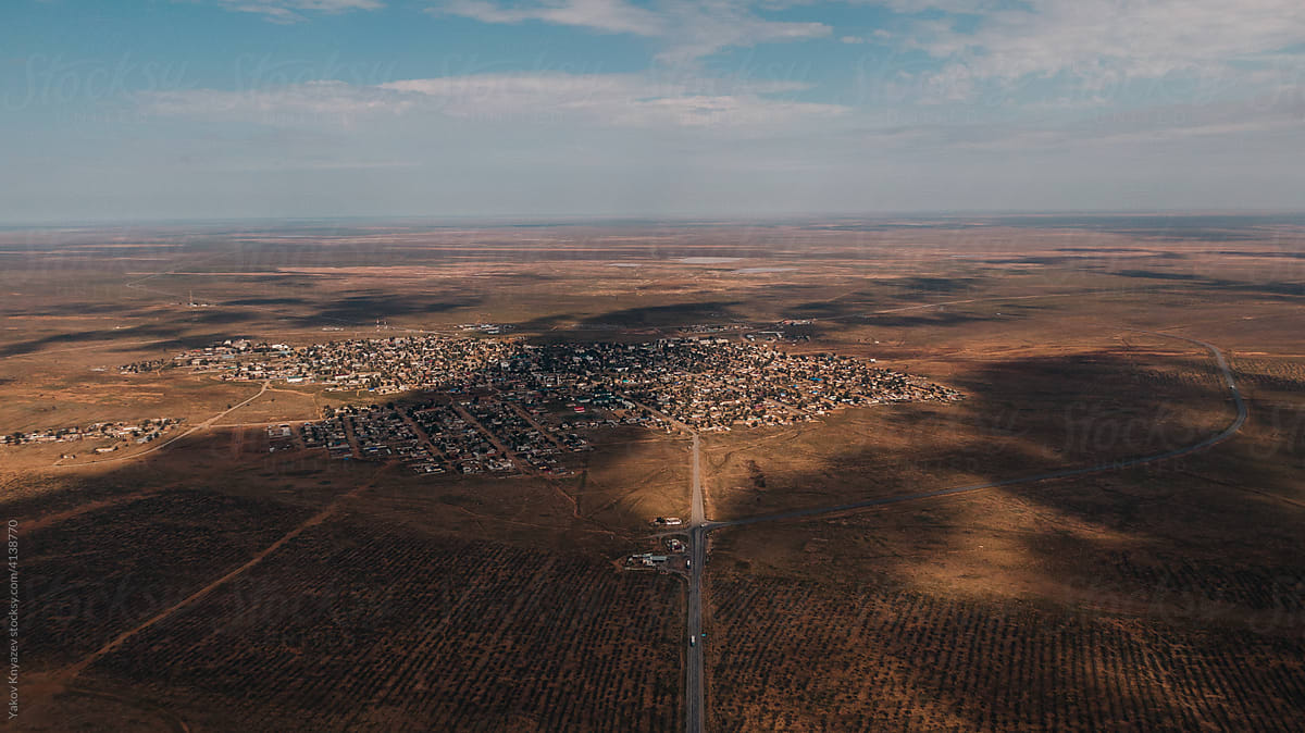 `aerial view of a small town in the middle of a desert