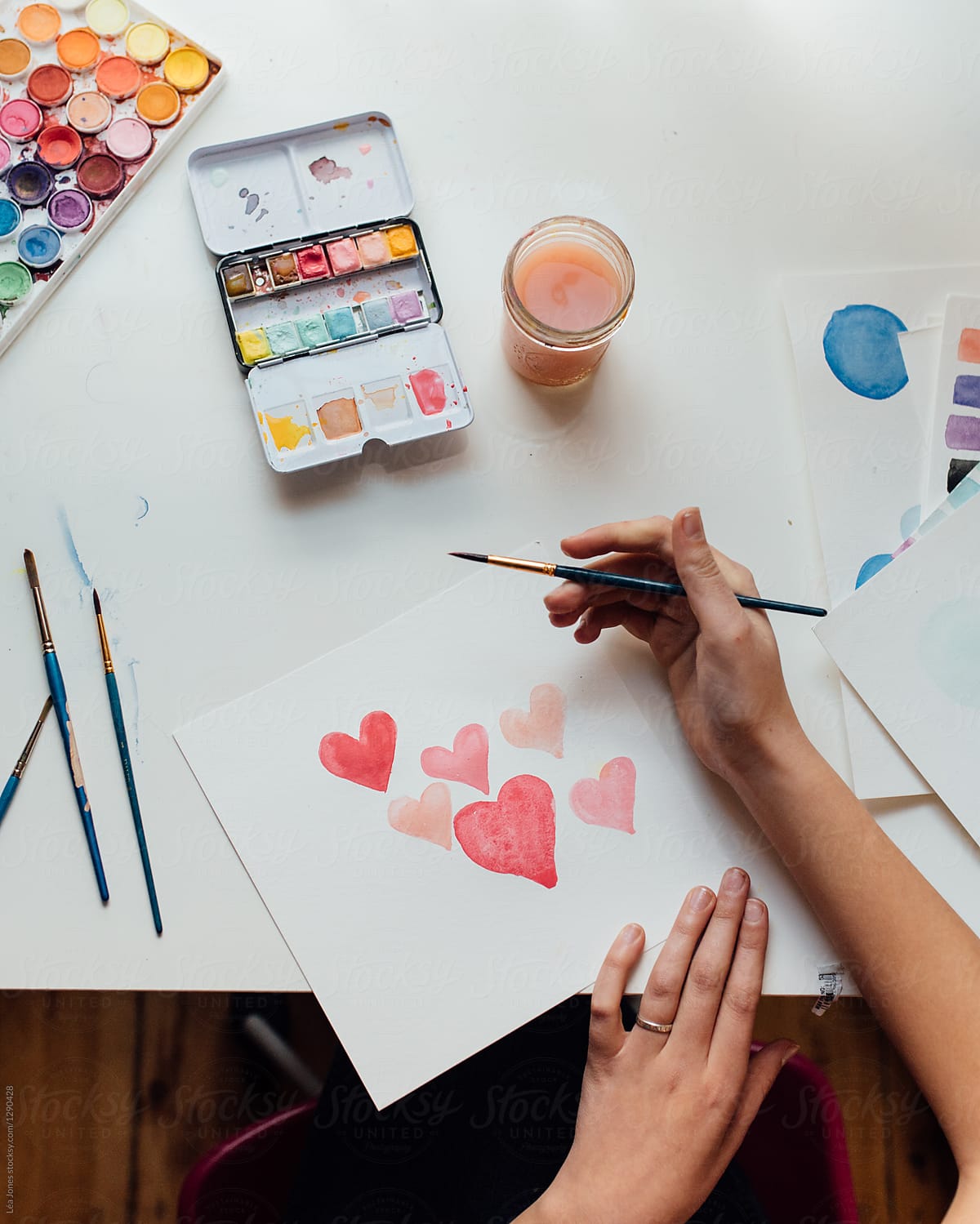 teen painting pink hearts in watercolours