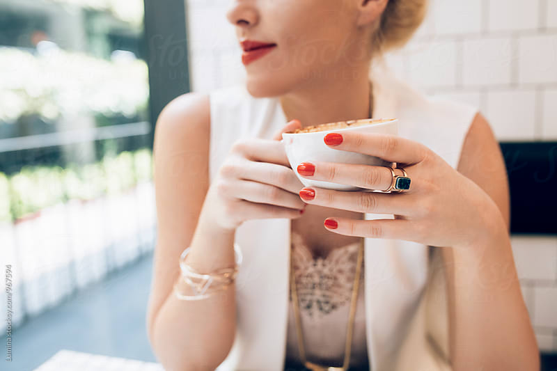 Elegant Woman Drinking Espresso at a Café