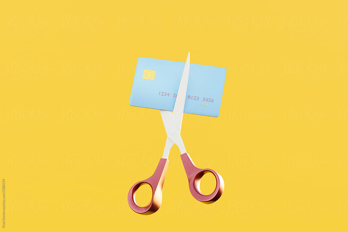Scissors cutting debit / credit card. Reduce / pay off debt concept.