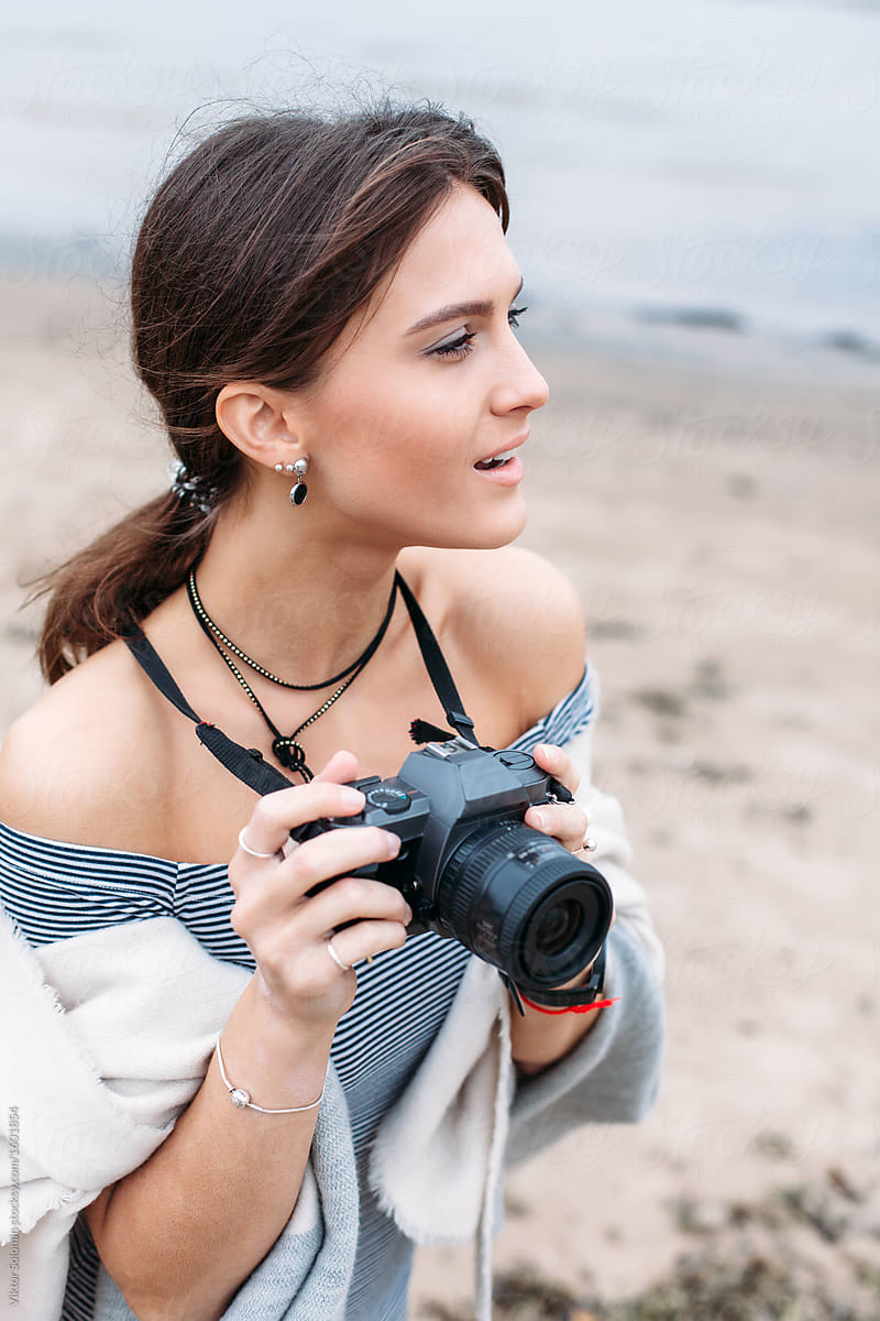 Beautiful young woman photographer outdoor portrait