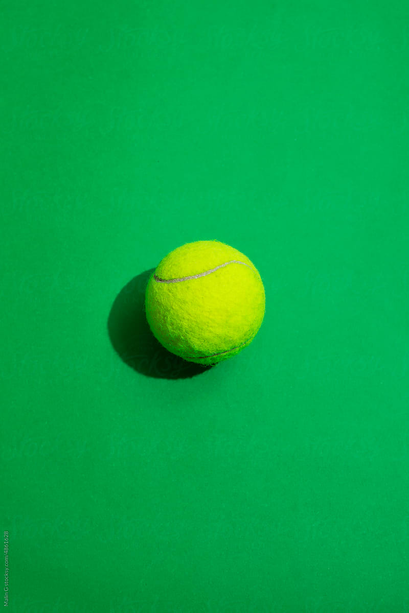 Tennis ball on a colorful background with hard lighting