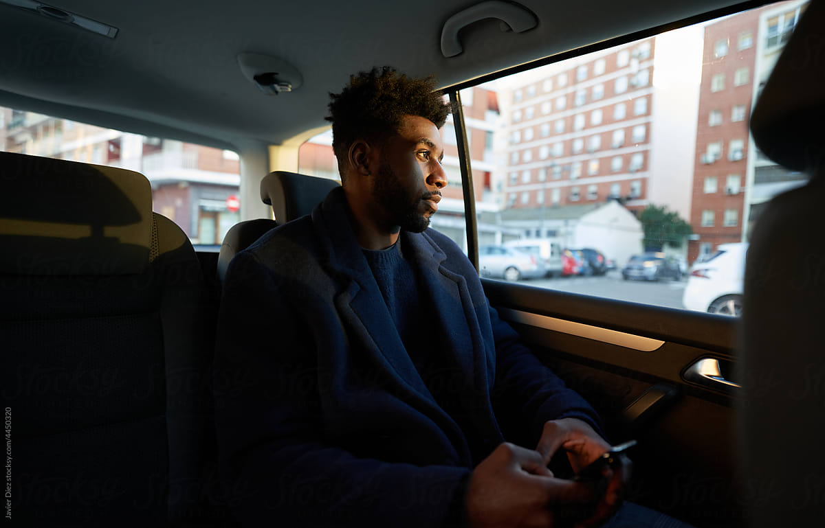 Male entrepreneur using smartphone in car
