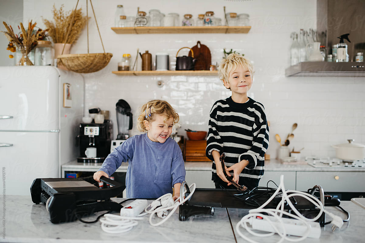 Cute kids playing with electronic products at home