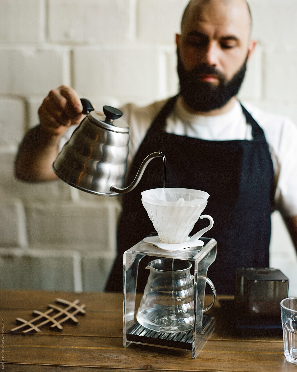 Barista pouring hot water in chemex