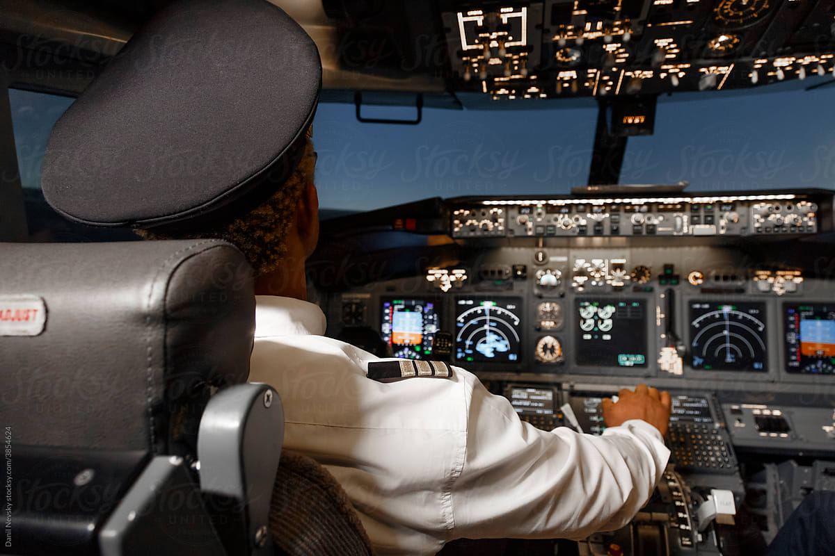 Unrecognizable black aviator in plane cockpit