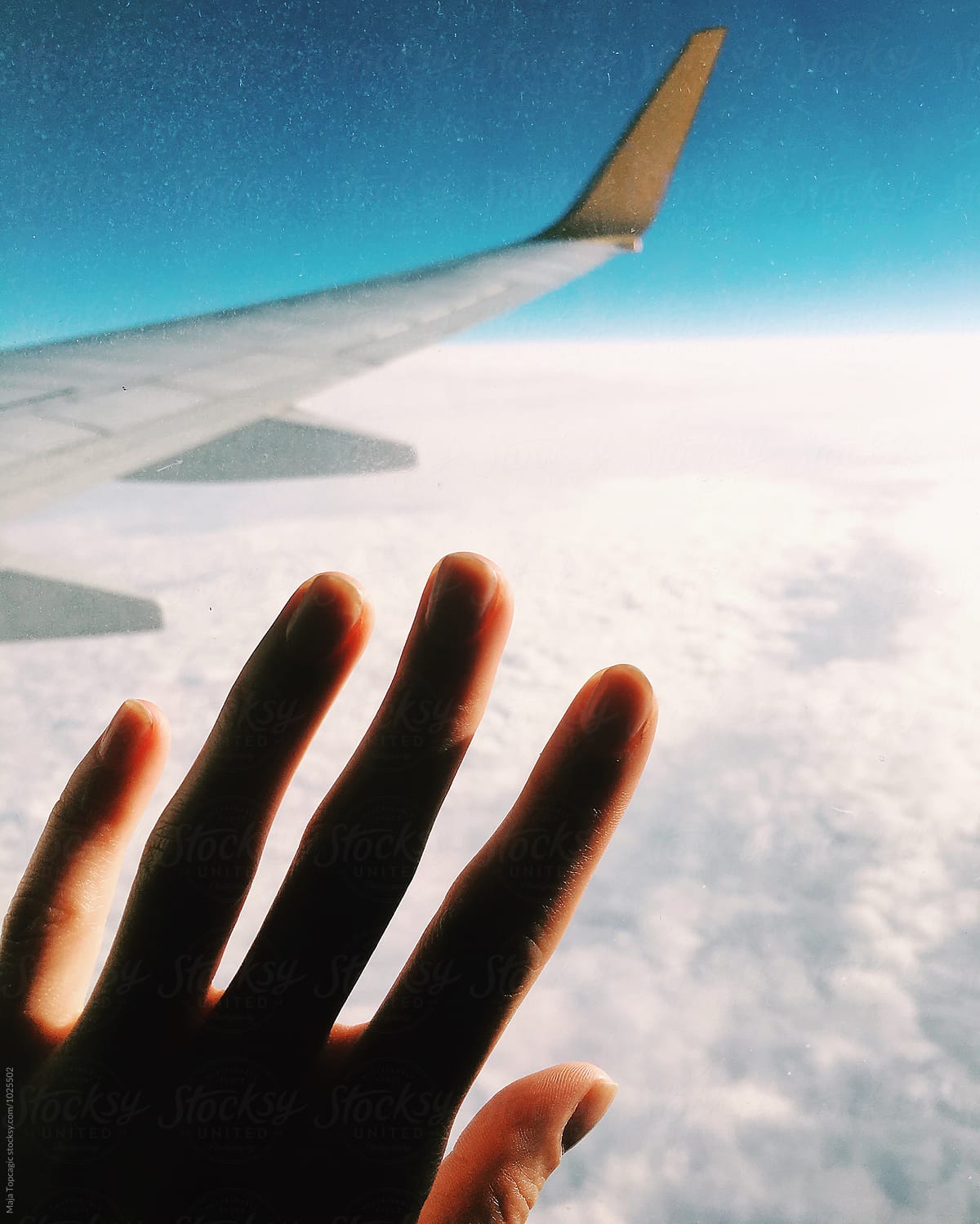 Female hand on an aeroplane window