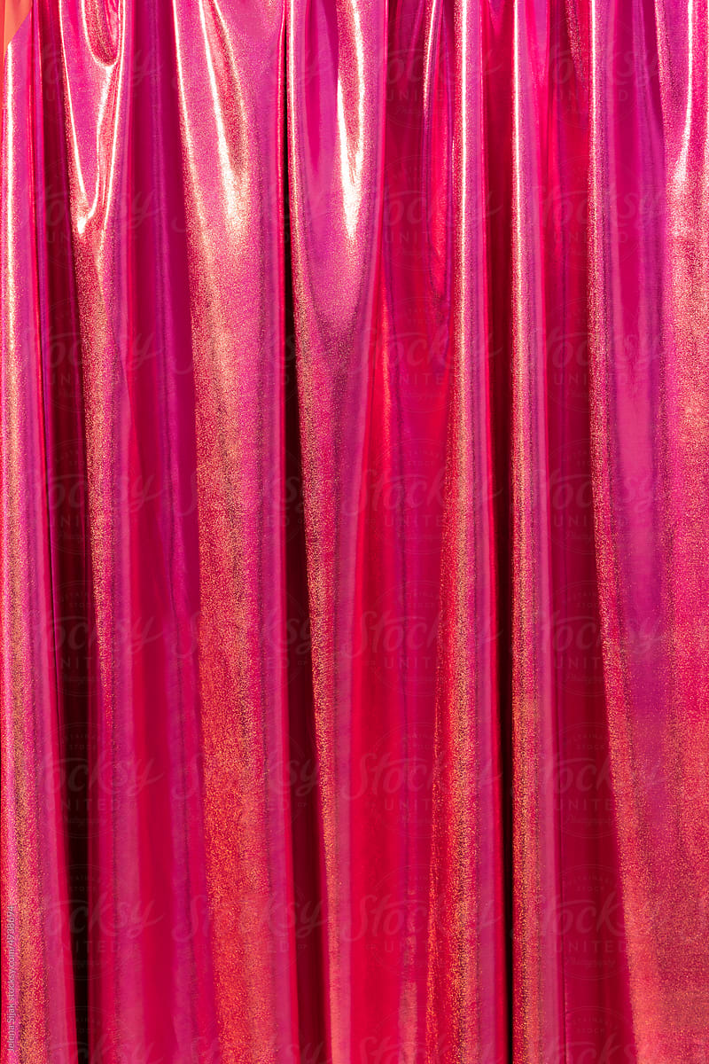 Pink curtain with subtle glitter and yellow shine. Empty space.