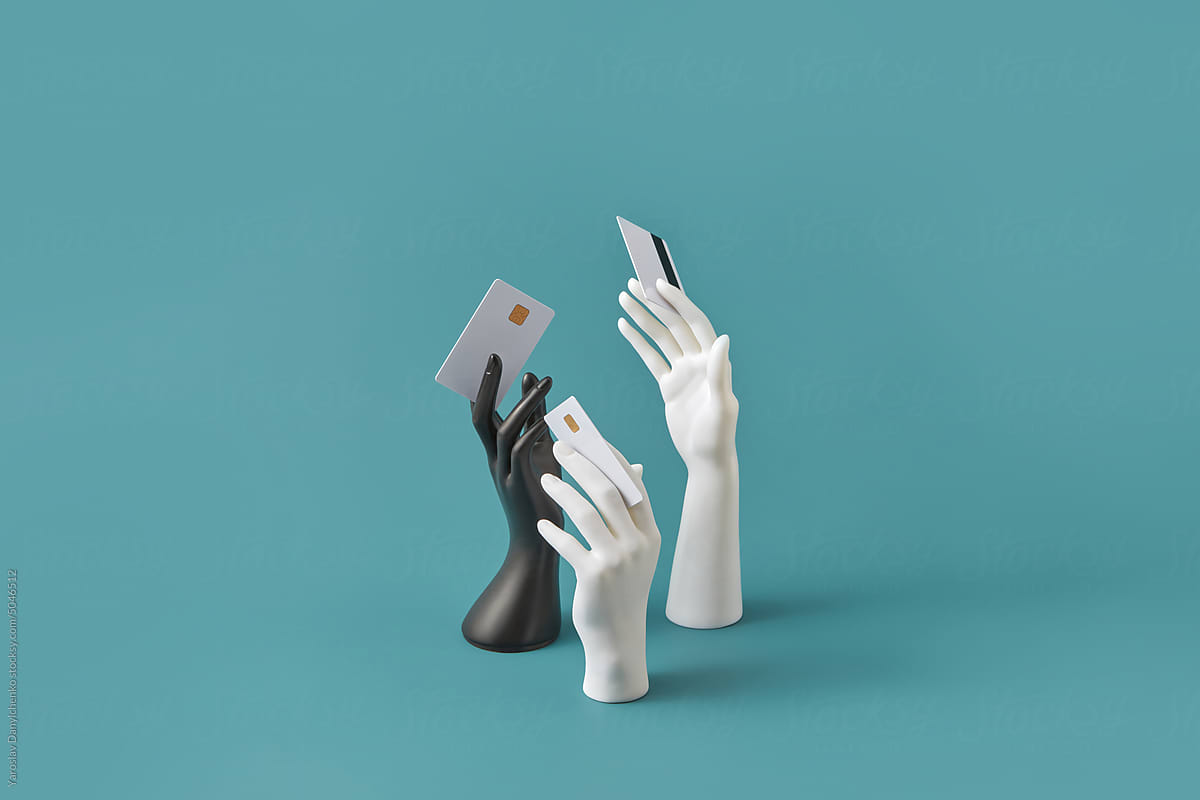 Black and white hands holding credit cards.