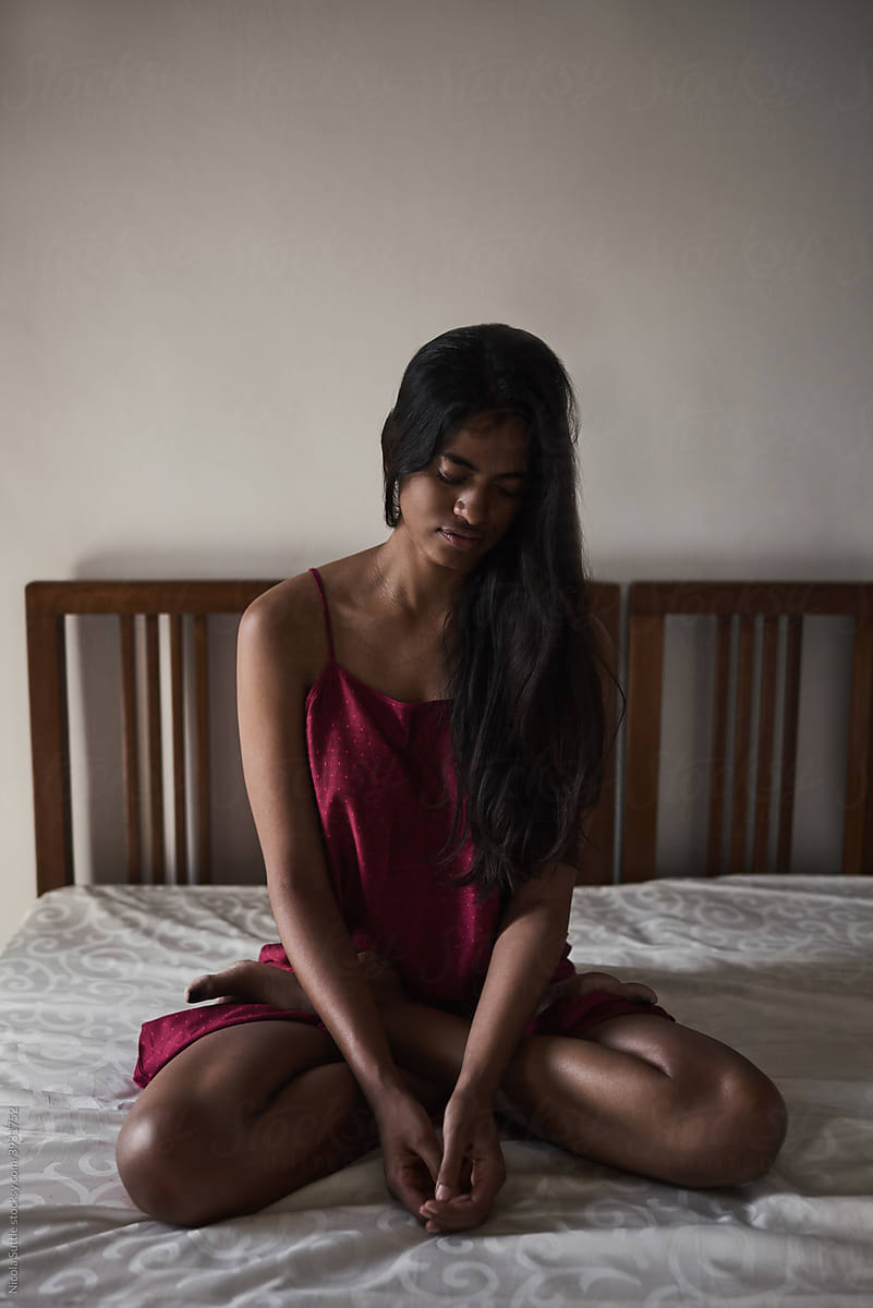 Lonely frustrated woman sitting on bed