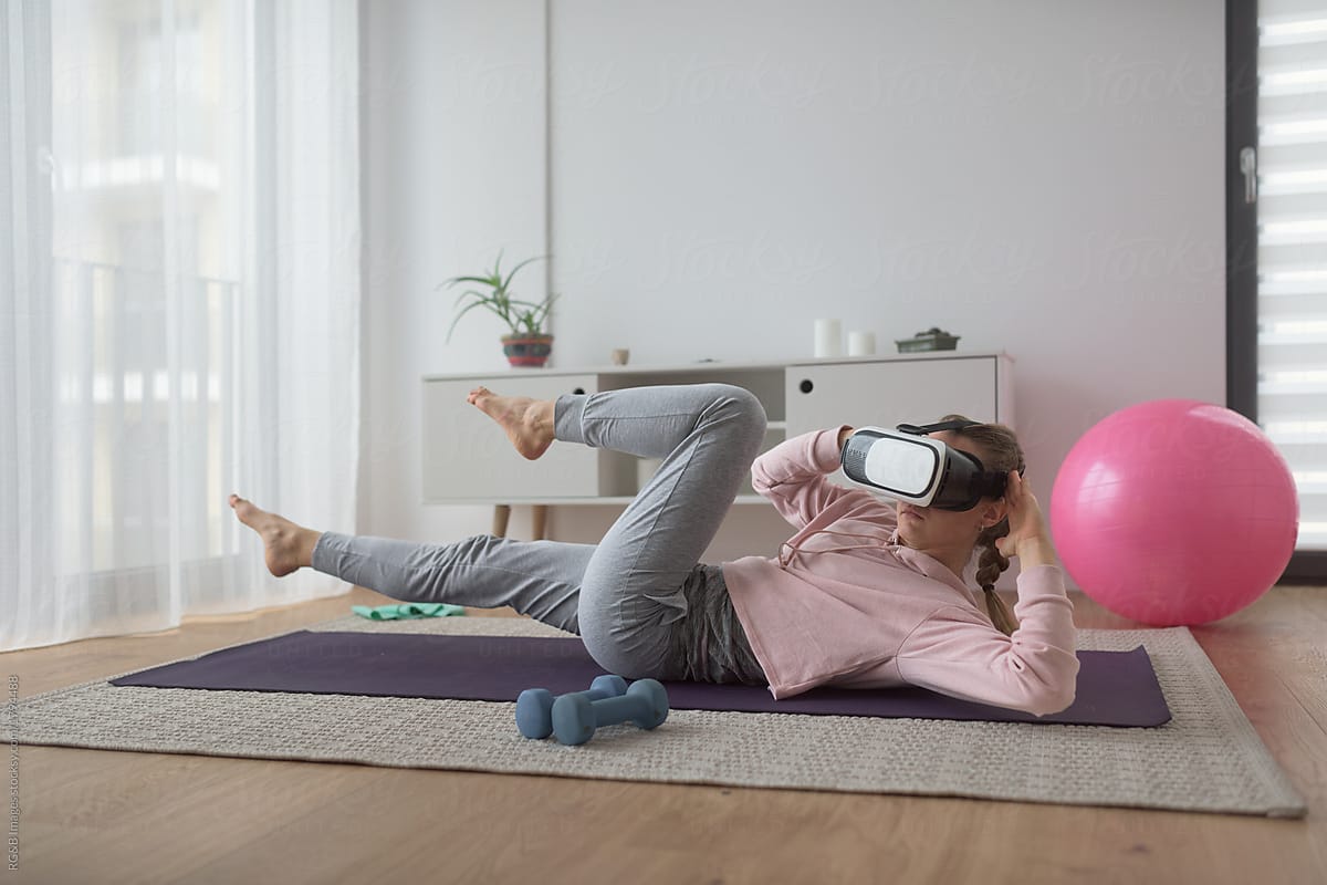 Woman training at home with virtual reality headset