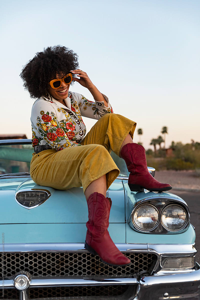 Smiling African American Woman next to Vintage American car