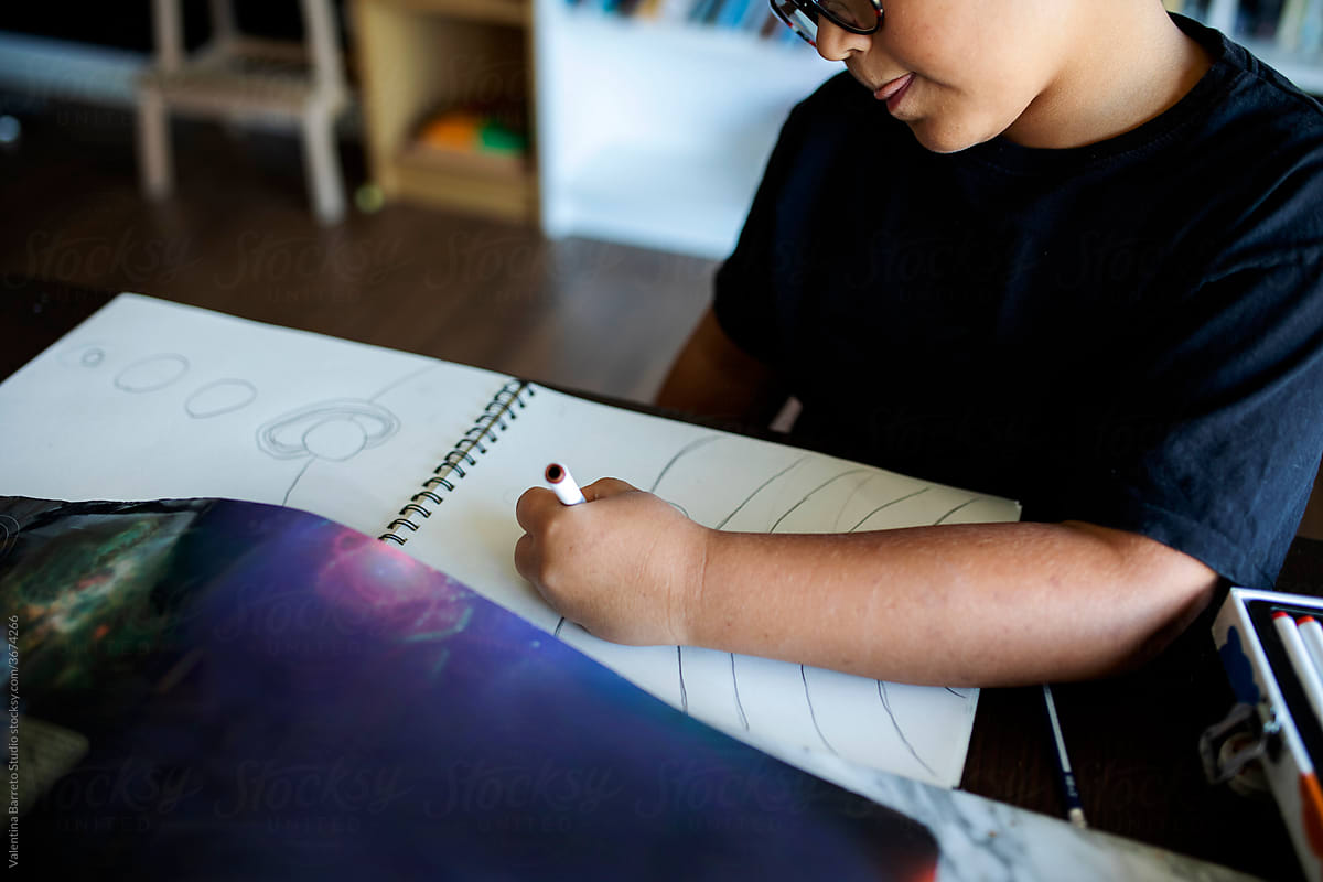 kid drawing planers and the solar system
