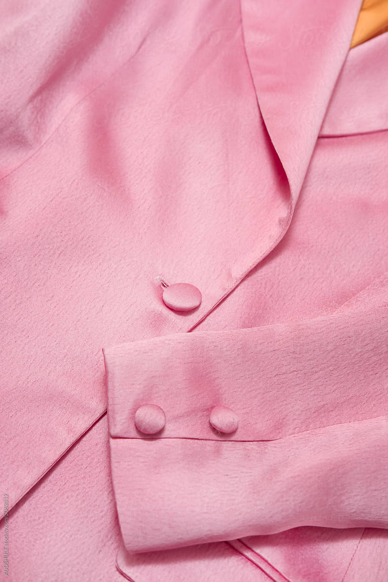 Pink blazer with buttons.