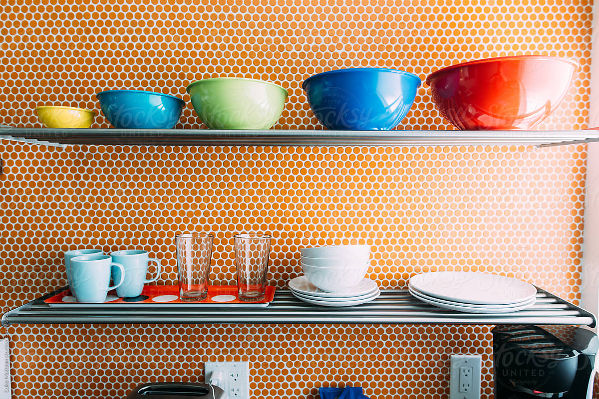 Cups, Bowls and Plates Organized On Kitchen Shelf