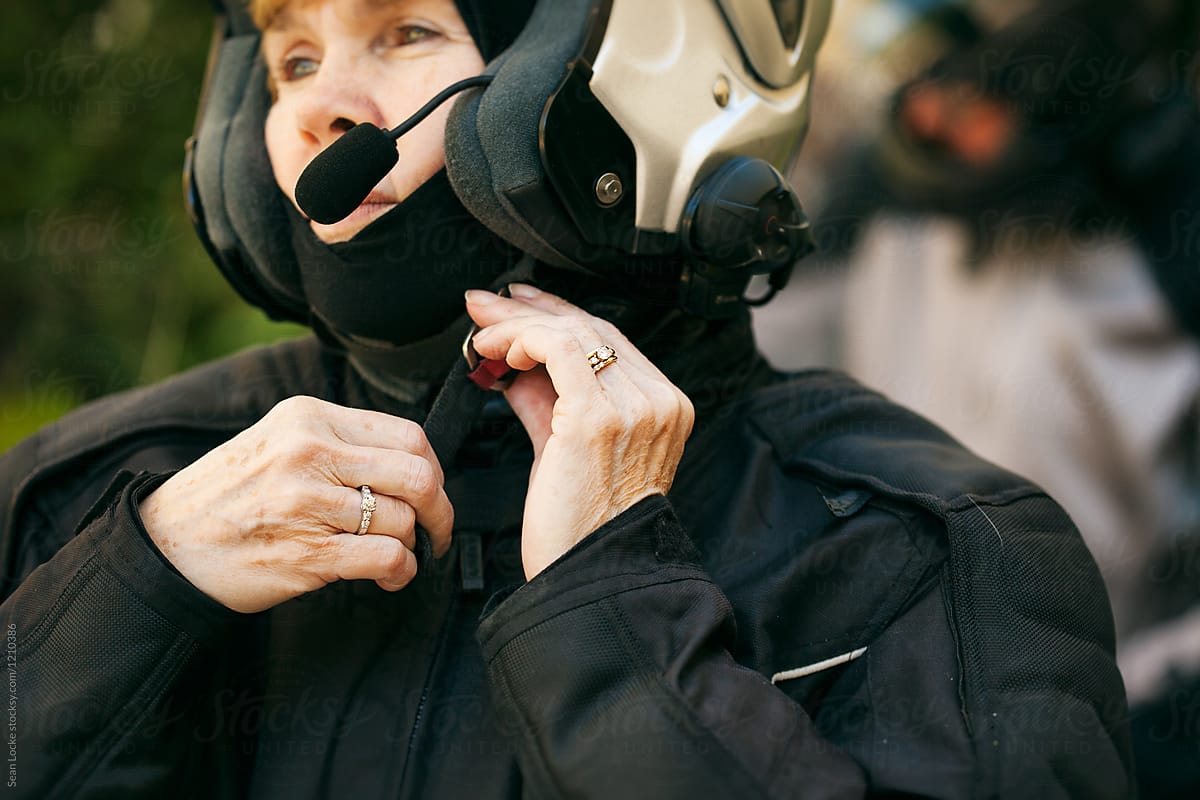 Rider: Female Biker Adjusts Helmet Strap
