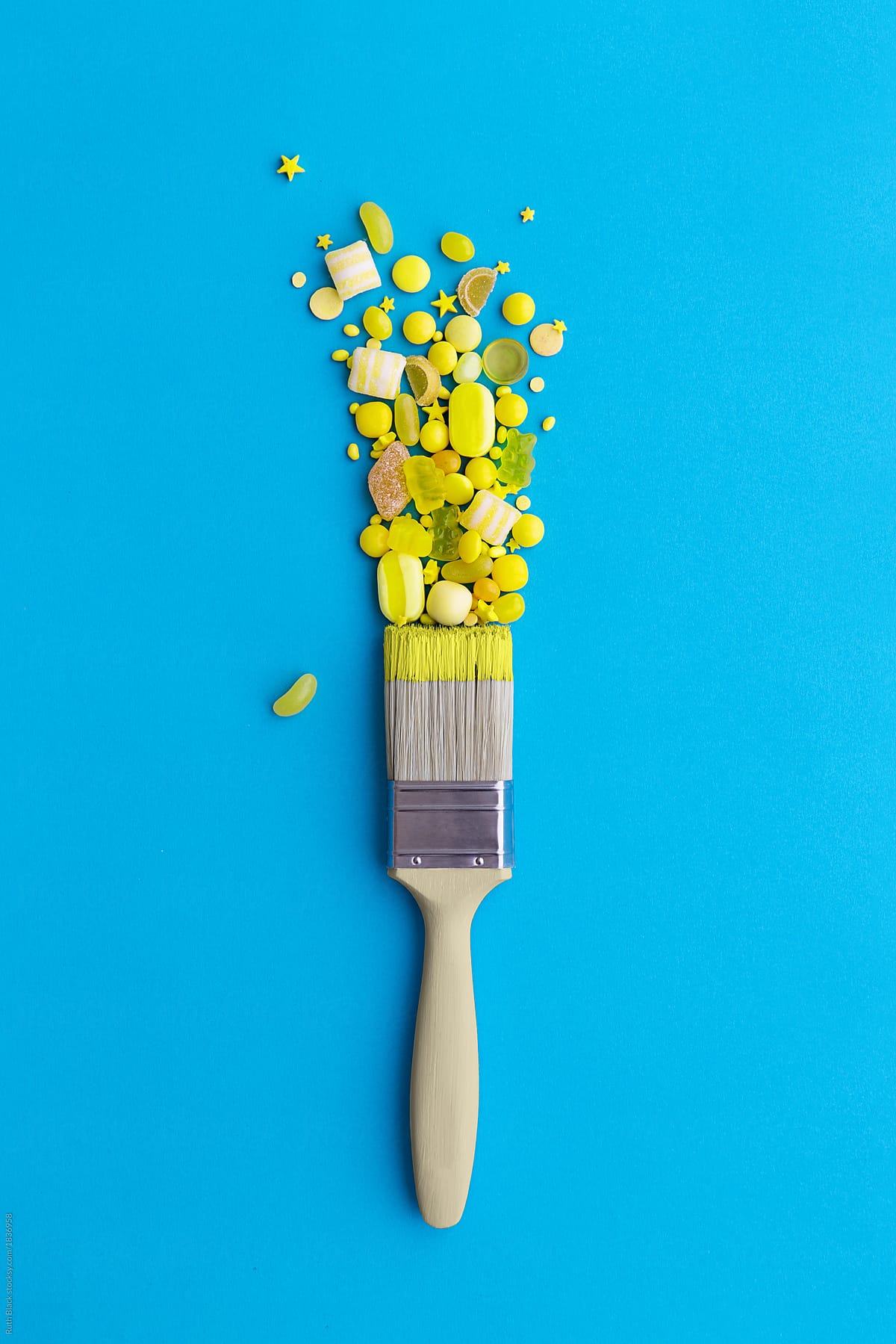 Yellow Paintbrush With Candy by Stocksy Contributor Ruth Black